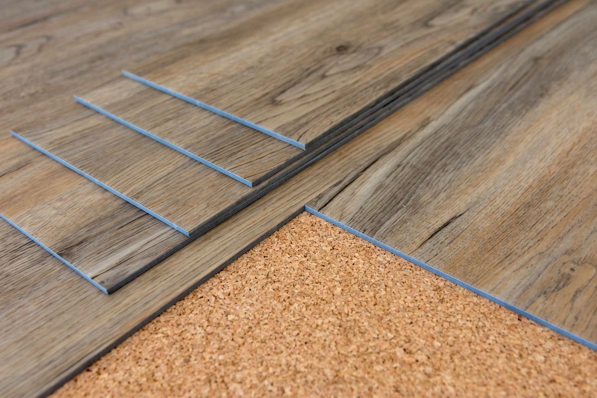 Detailed close-up of a wooden floor showcasing cork flooring, emphasizing the unique texture and warm tones of the material. 