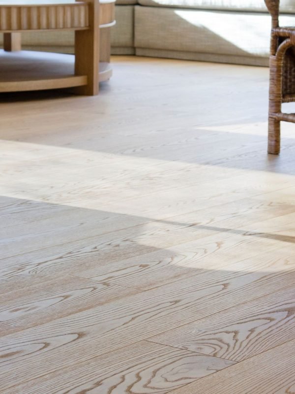 Interior view of a room with a wooden floor and a chair, highlighting flooring services available in Aurora, CO.
